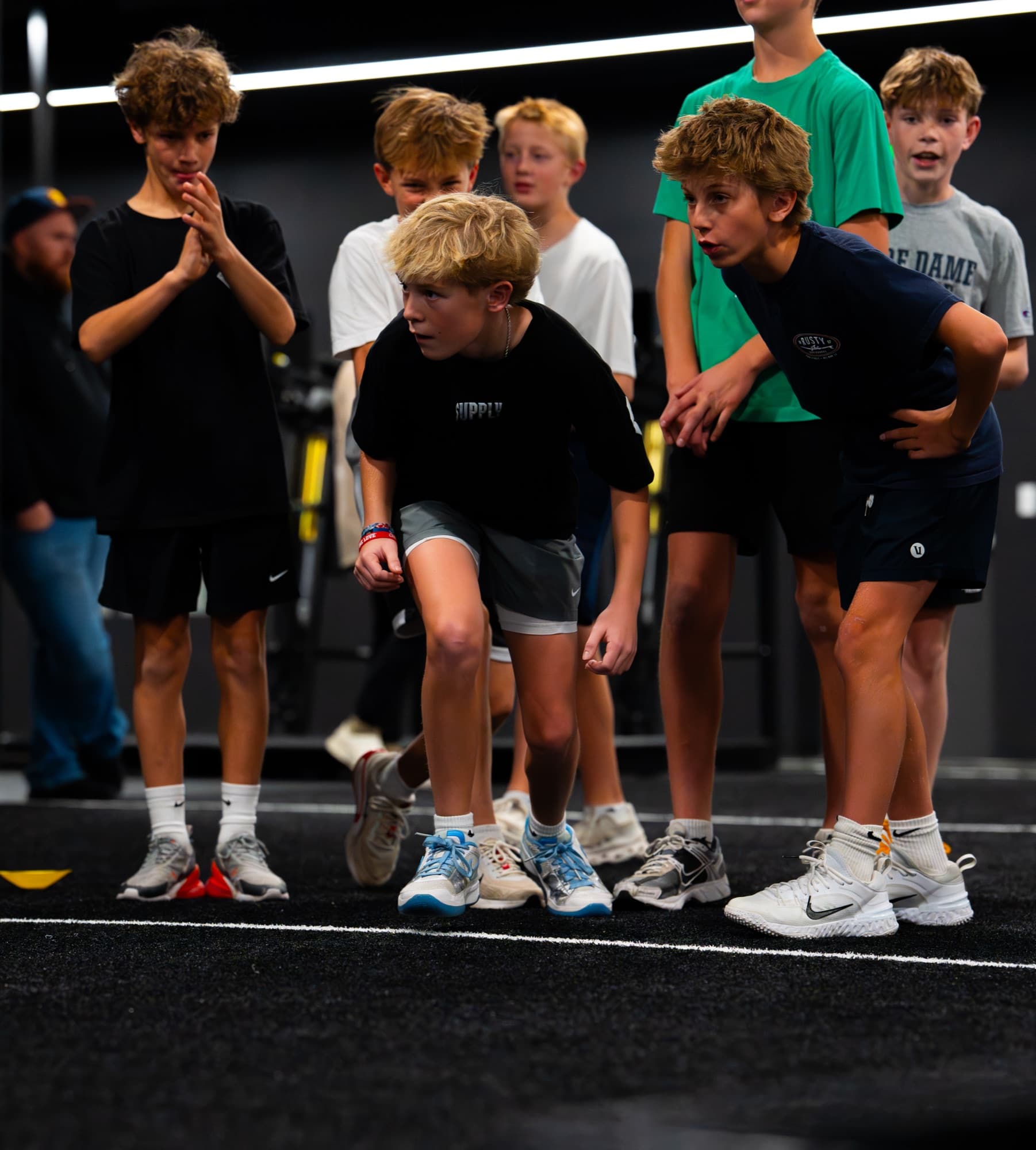 Young athletes at the start line during an indoor training session