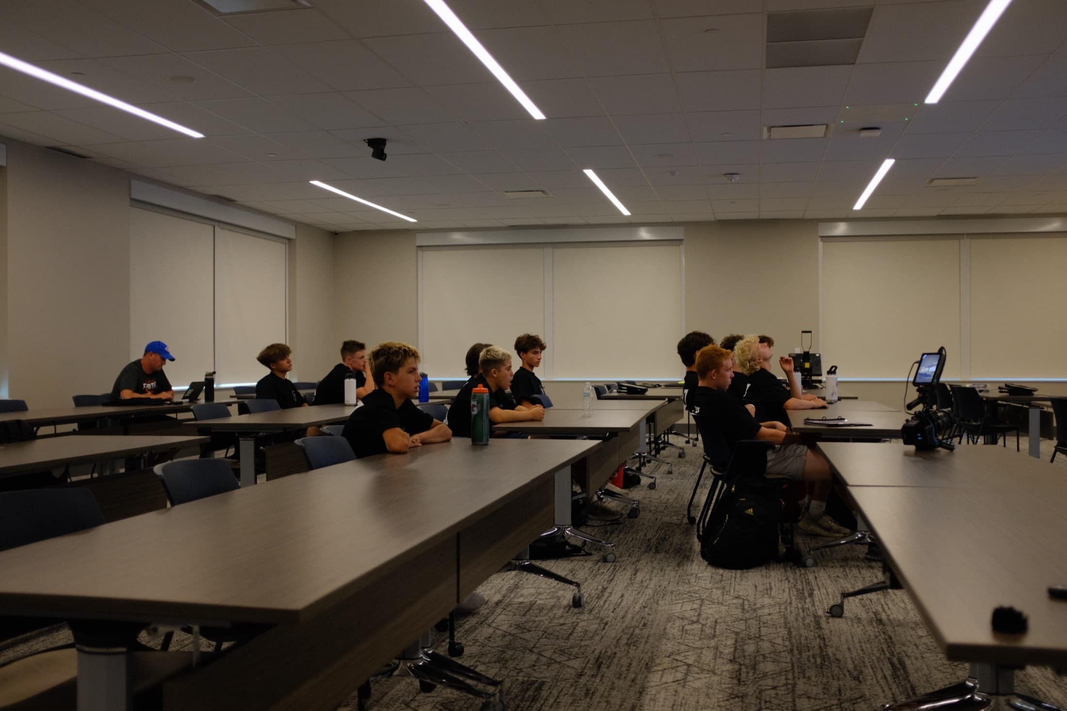 Student-athletes seated in a classroom during a team session